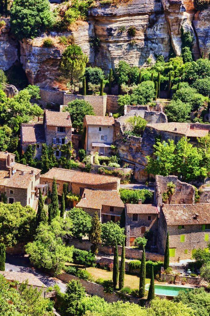aerial view of a Mediterranean village with typical houses and emerald thujas